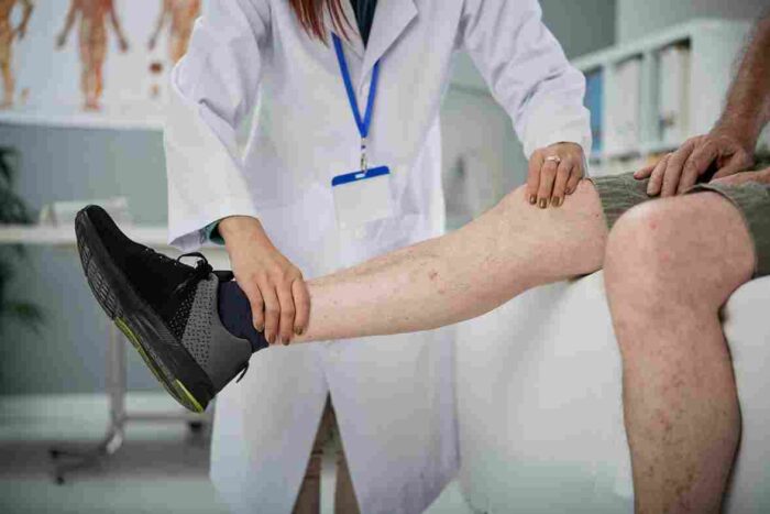 physiotherapist palpating leg 11zon